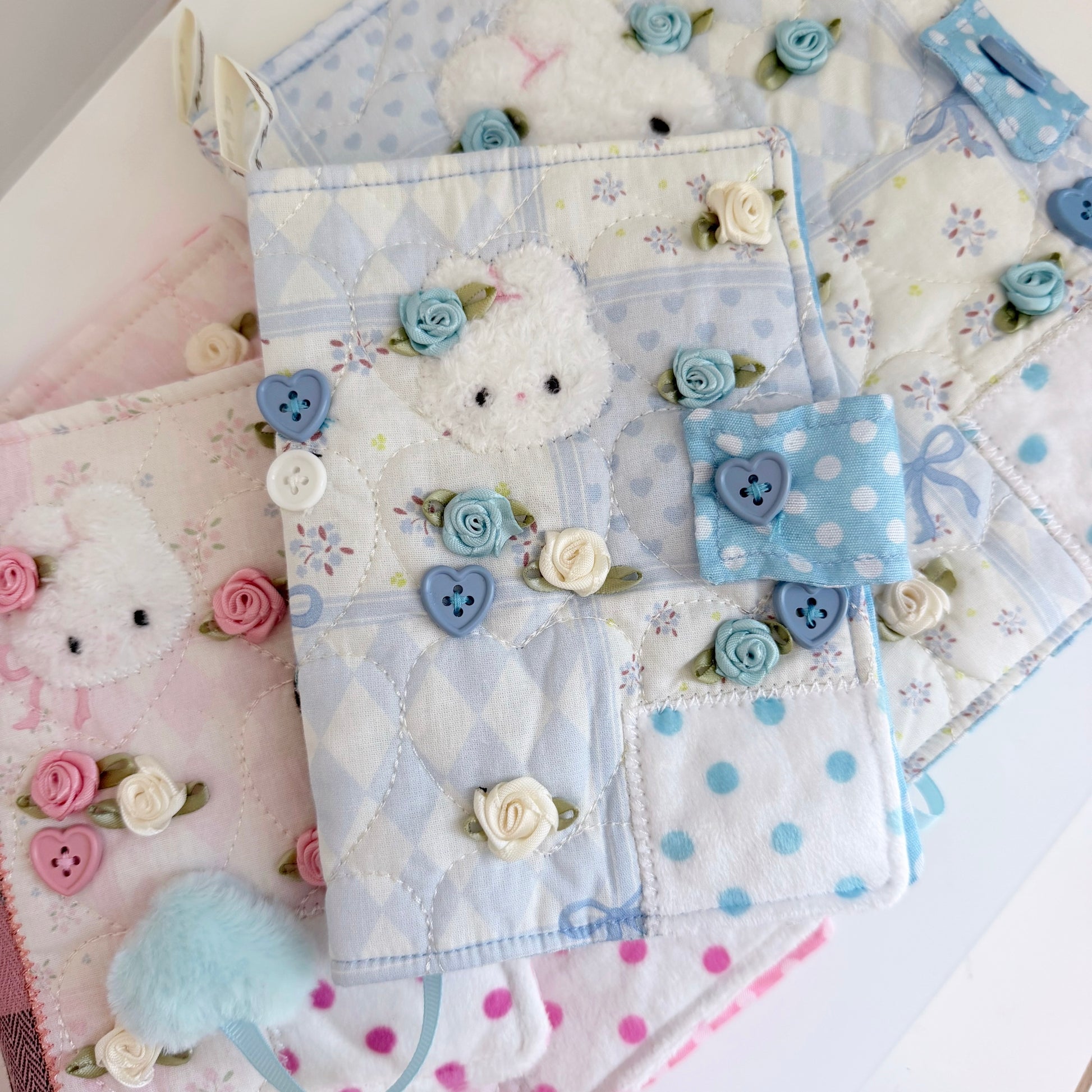 Blue A6 fabric journal covers on a white surface