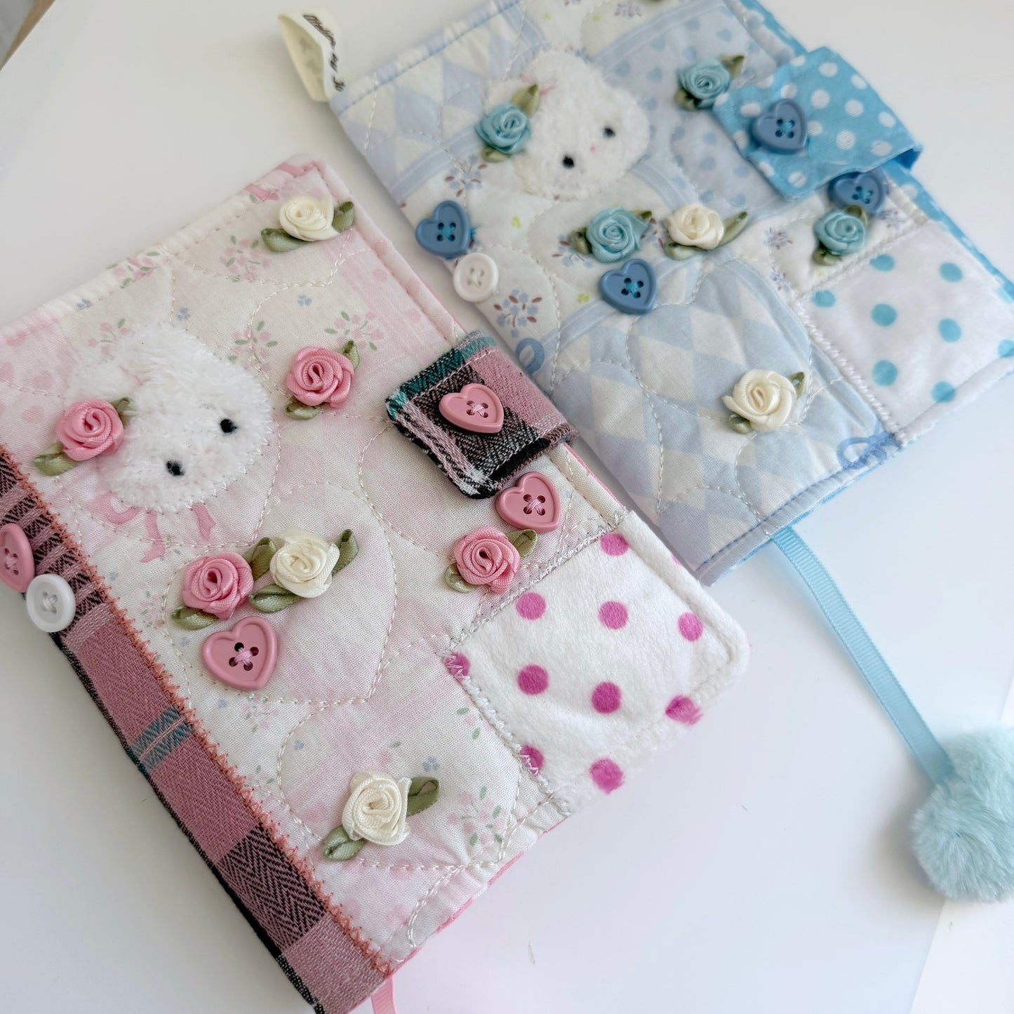 Blue and Pink A6 fabric journal covers on a white surface