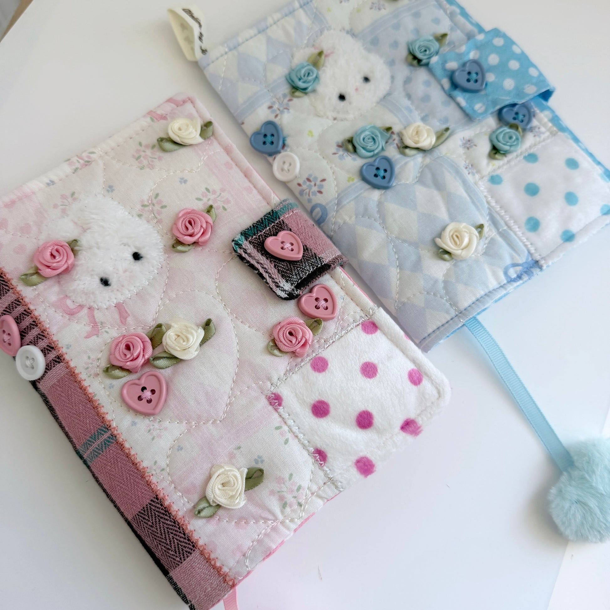 Blue and Pink A6 fabric journal covers on a white surface