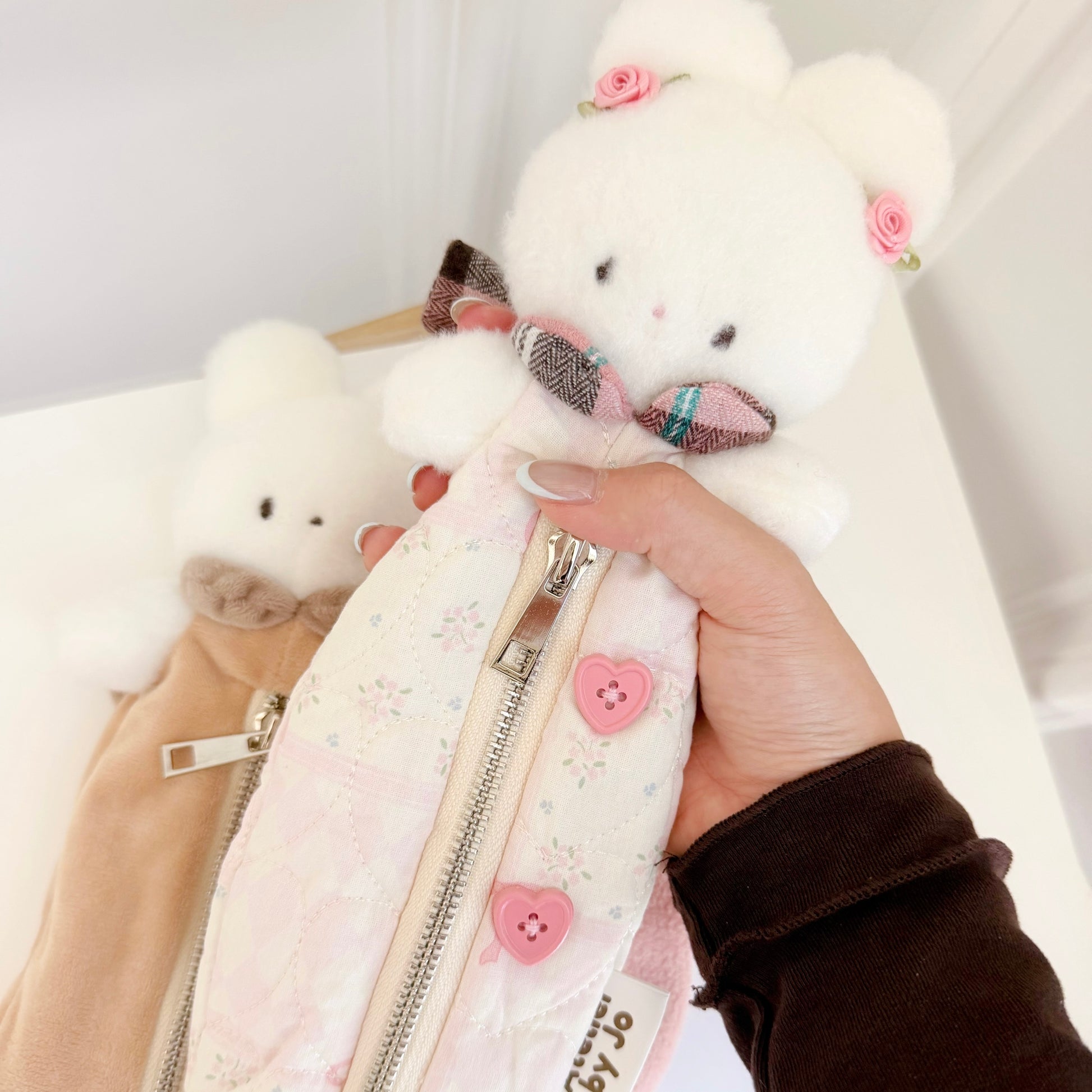 Hand holding pink bunny pencil pouch