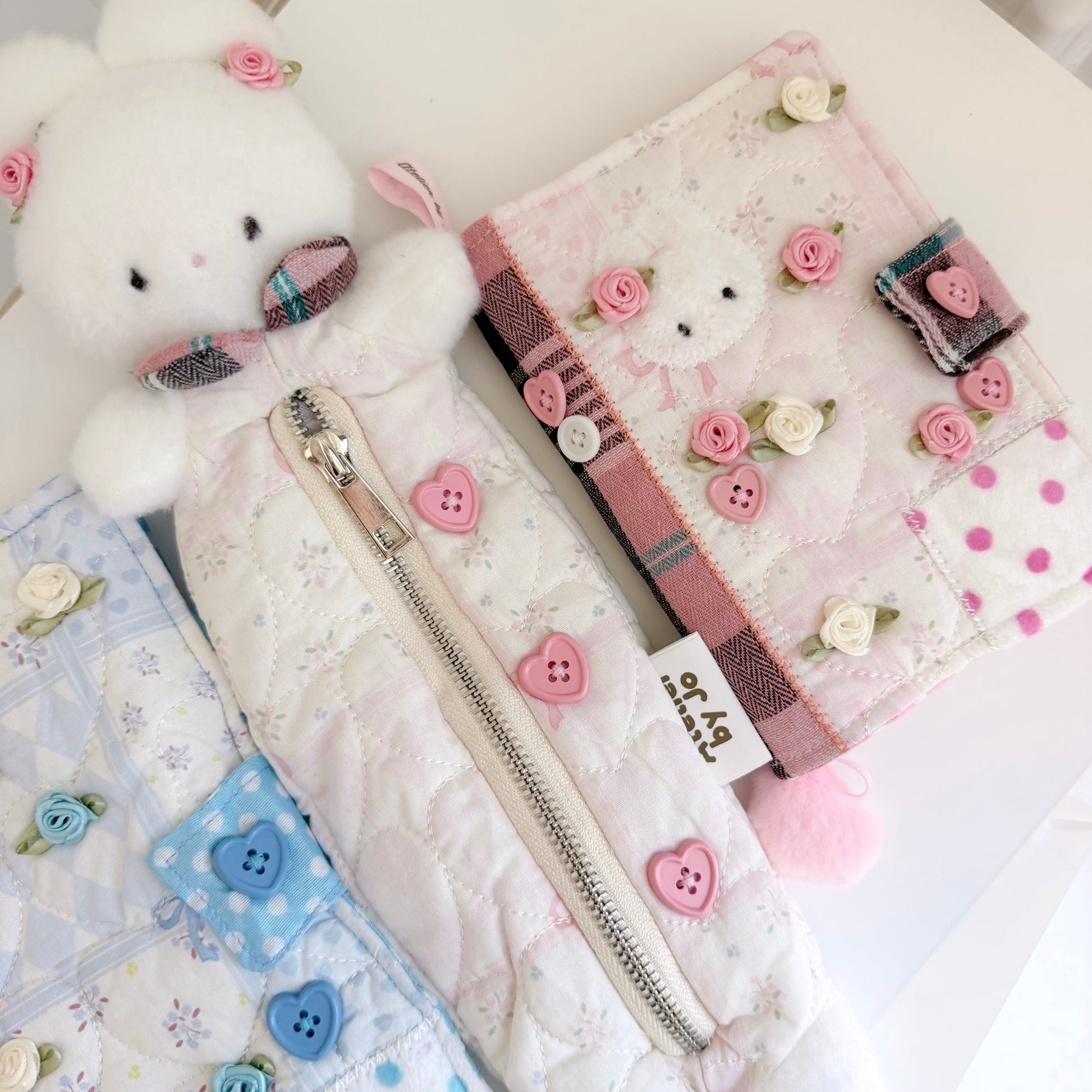 Pink bunny pencil pouch and Pink A6 journal cover on white surface