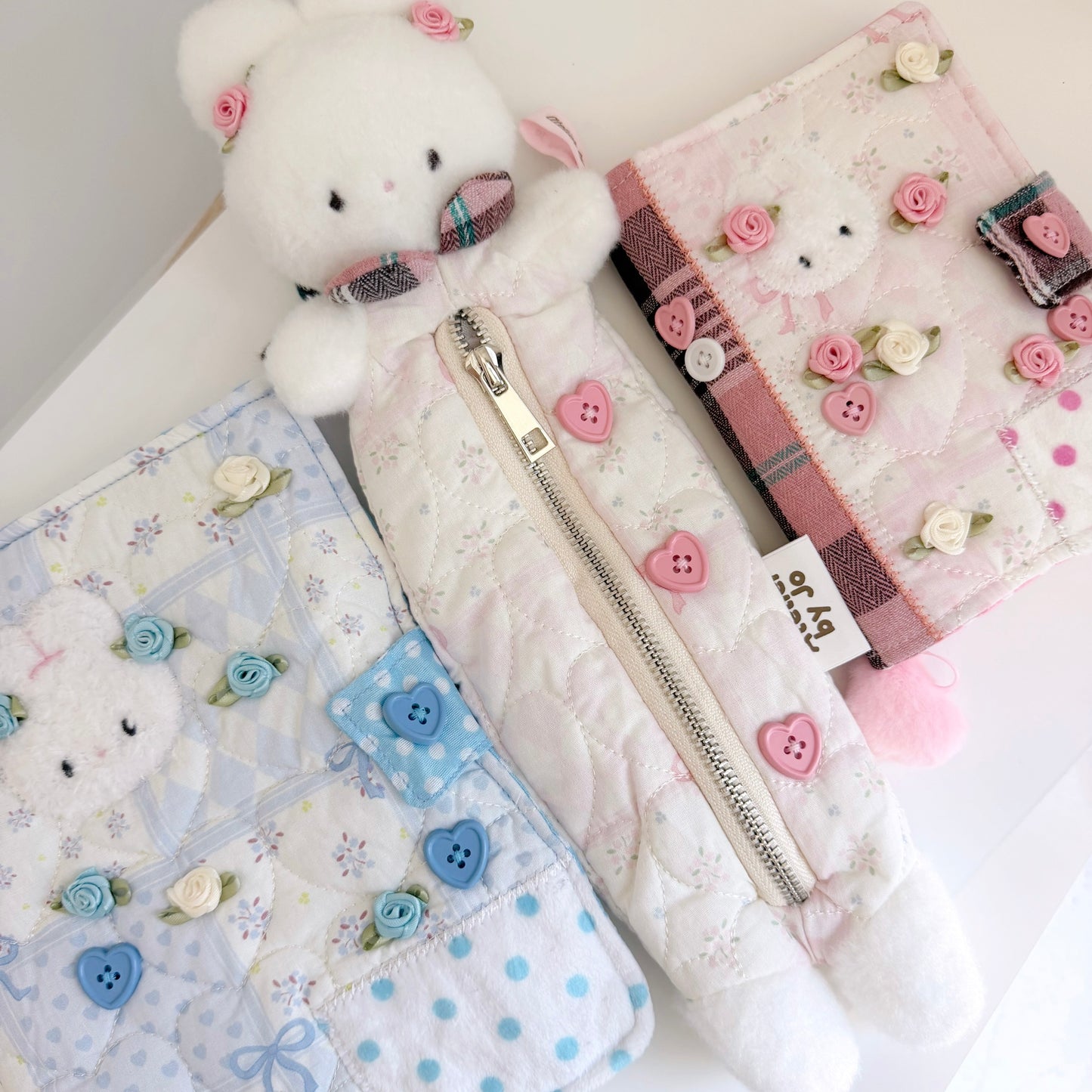 Pink bunny pencil pouch, Pink A6 and Blue A5 journal cover on white surface