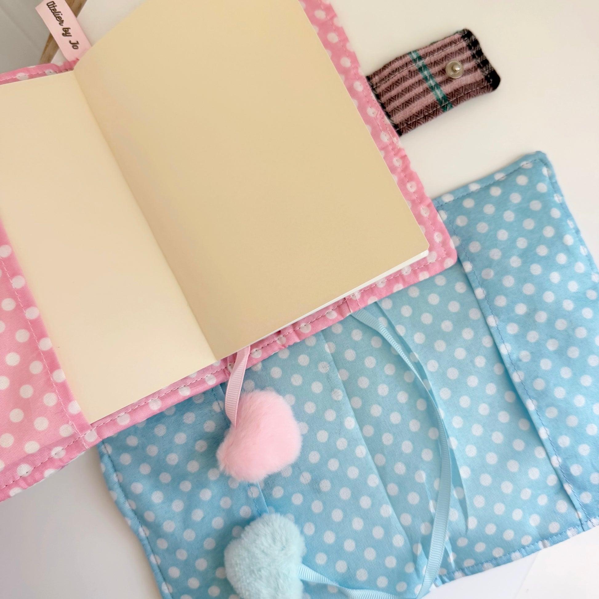 Blue and Pink A6 fabric journal covers polka dot pattern inside view on a white surface