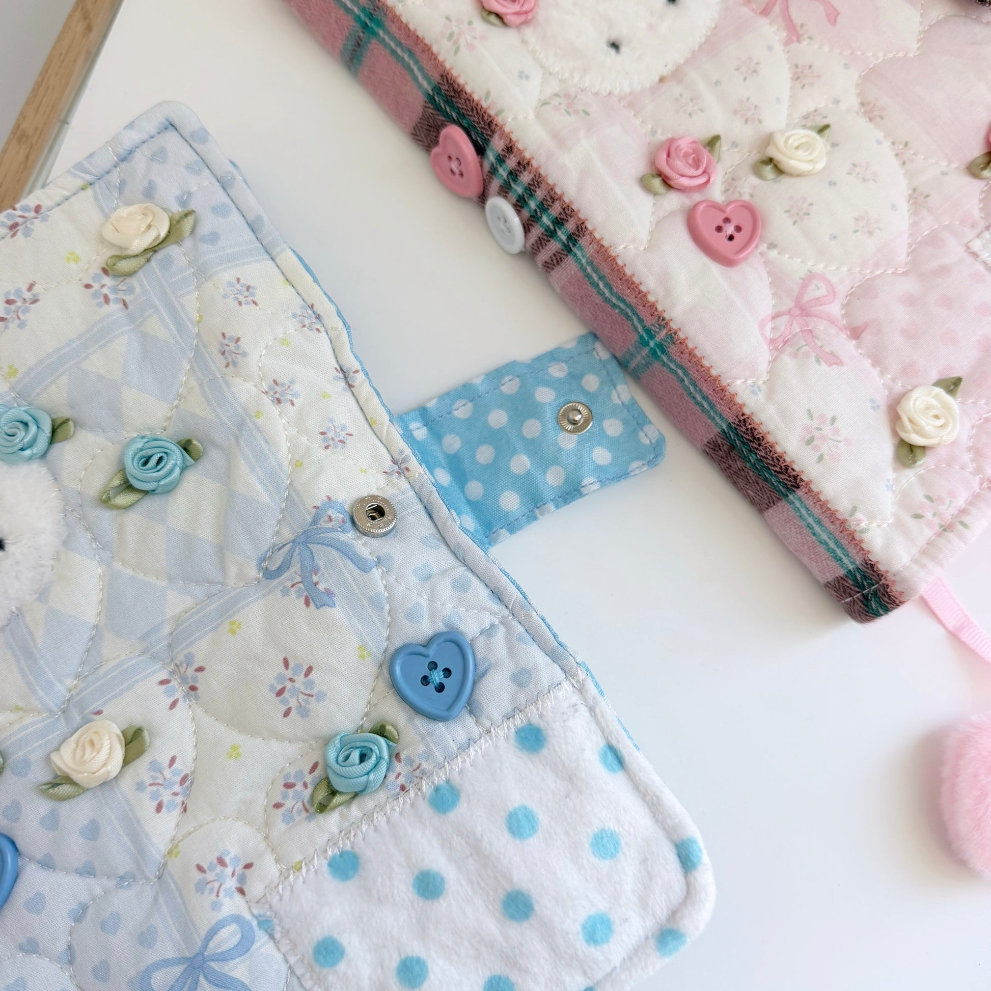 Blue and Pink A5 fabric journal covers on a white surface