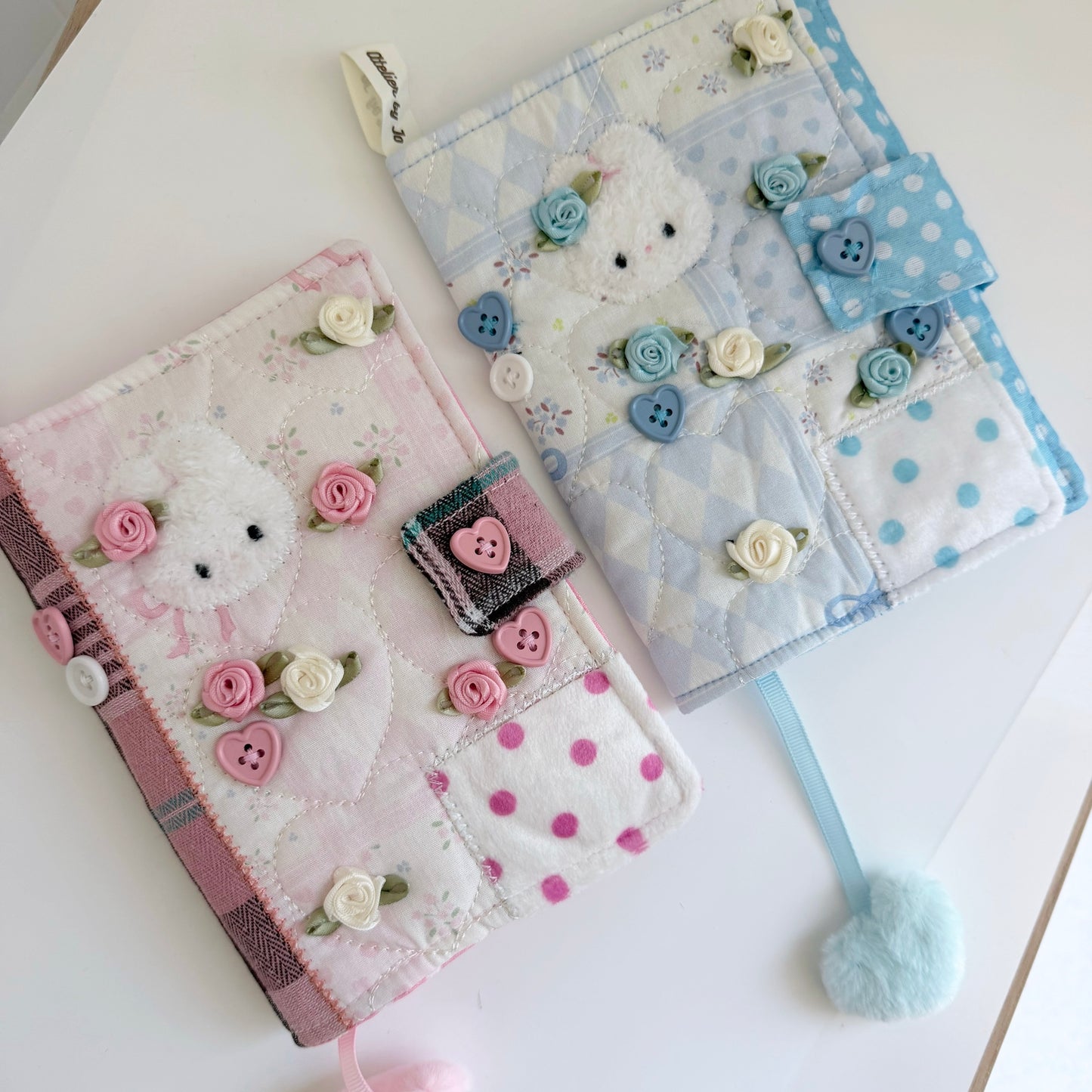 Blue and Pink A6 fabric journal covers on a white surface