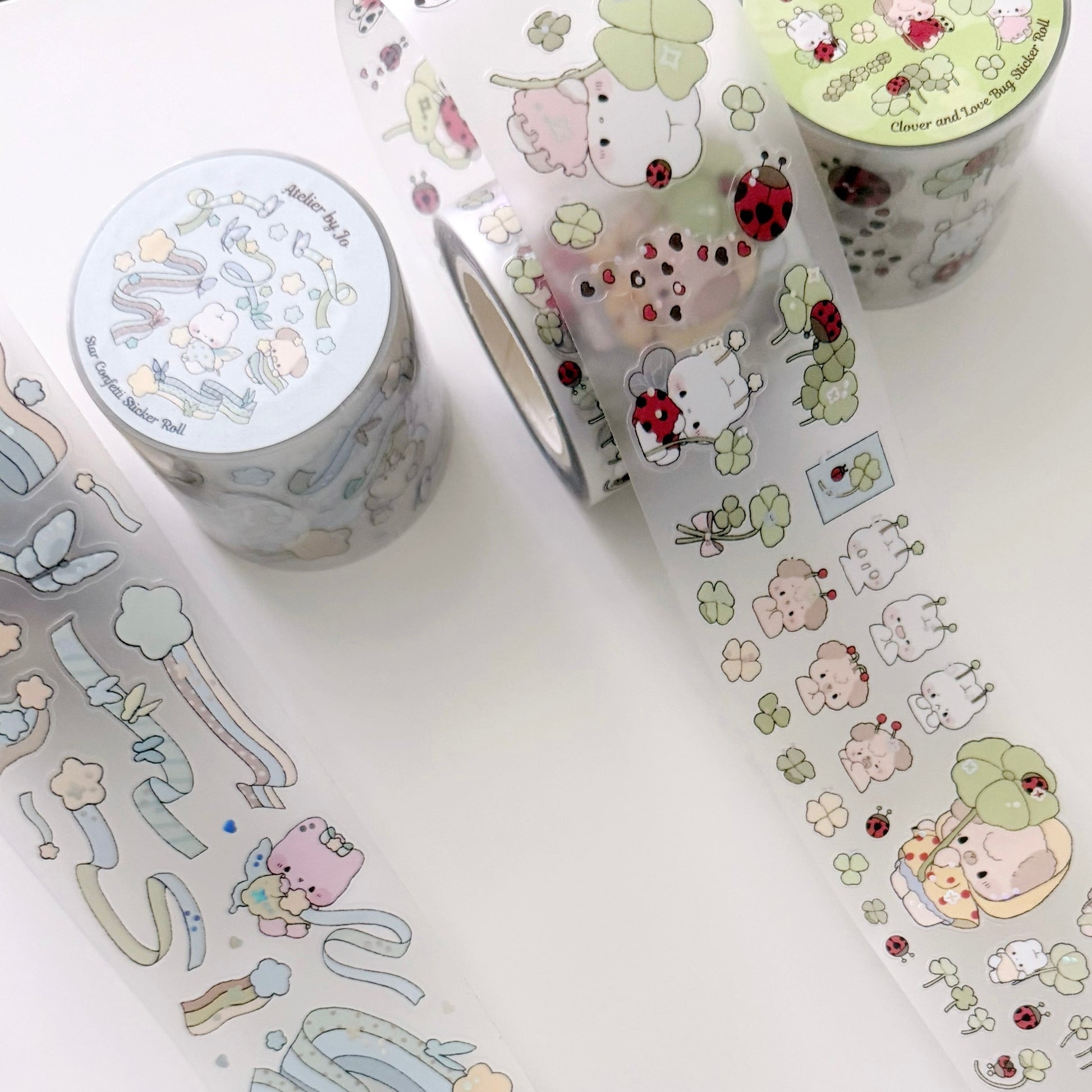 Decorative washi tape rolls with cute designs on a white surface