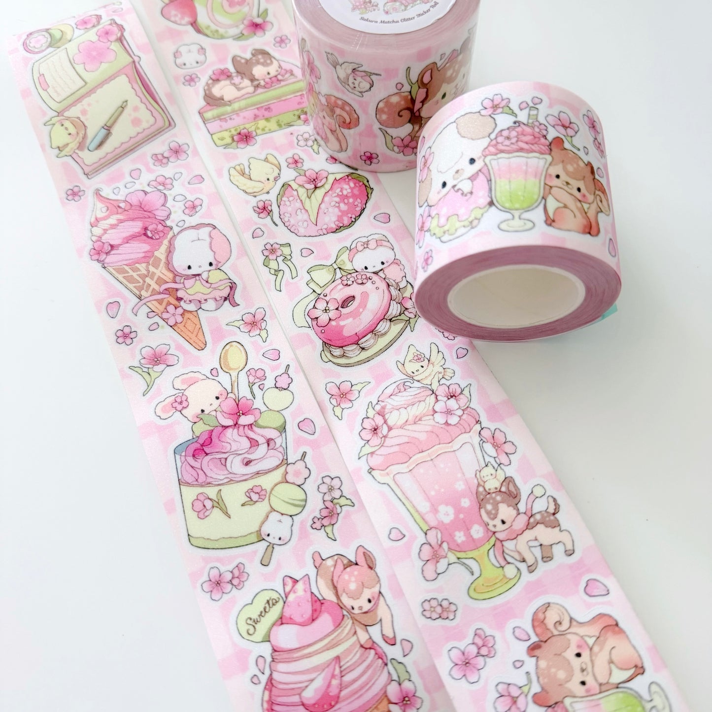 Three rolls of pink decorative tape with cute illustrations on a white background