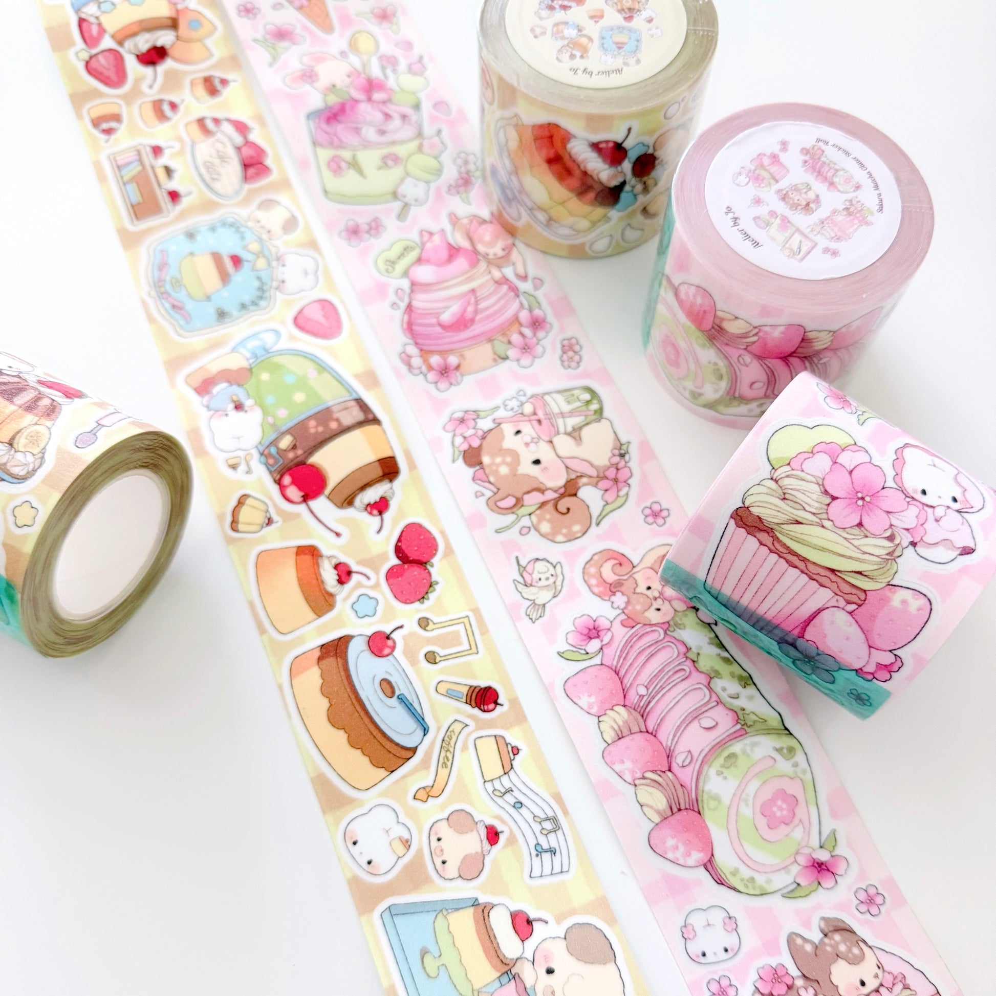 Decorative tape rolls with cute designs on a white background
