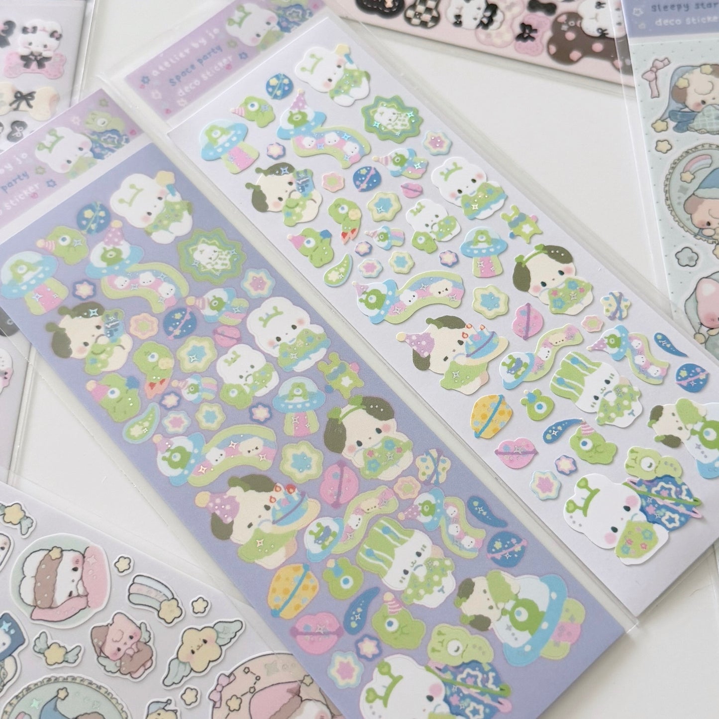 Several sheets of cute cartoon stickers arranged on a white surface. The stickers feature pastel-colored animal characters, flowers, stars, and small objects in soft shades of green, pink, blue, yellow, and lavender.