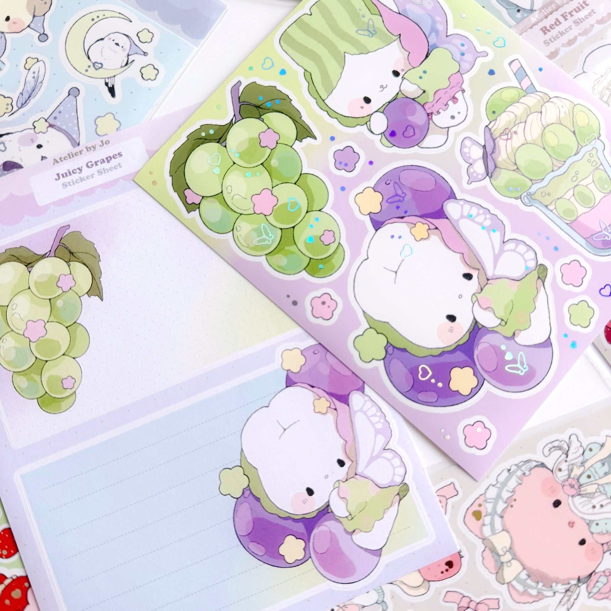 Set of cute animal-themed stickers with green grapes and other characters on a colorful background.