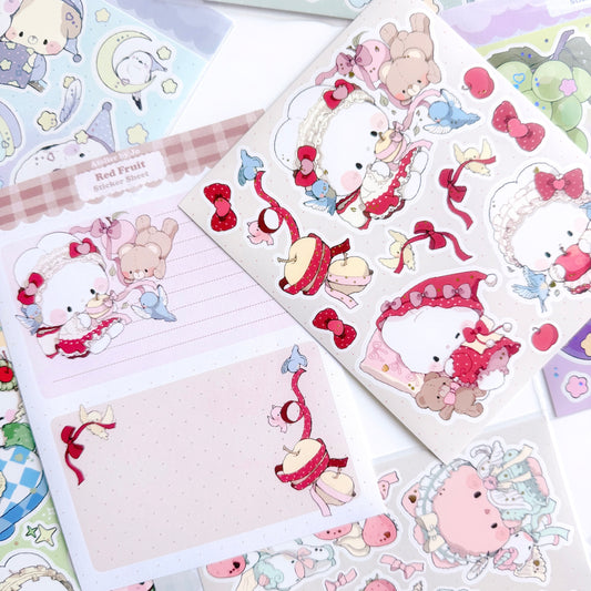Sticker sheet with cute animal characters and decorative elements on a beige background