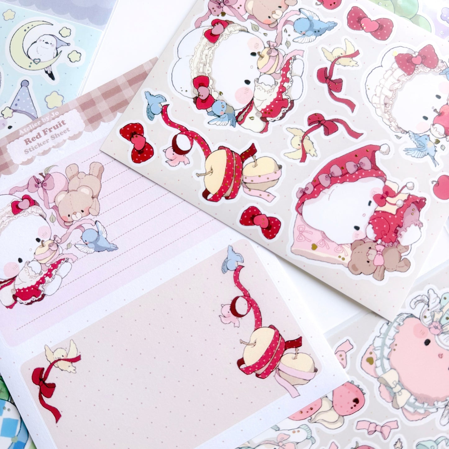 Sticker sheet with cute animal characters and decorative elements on a beige background