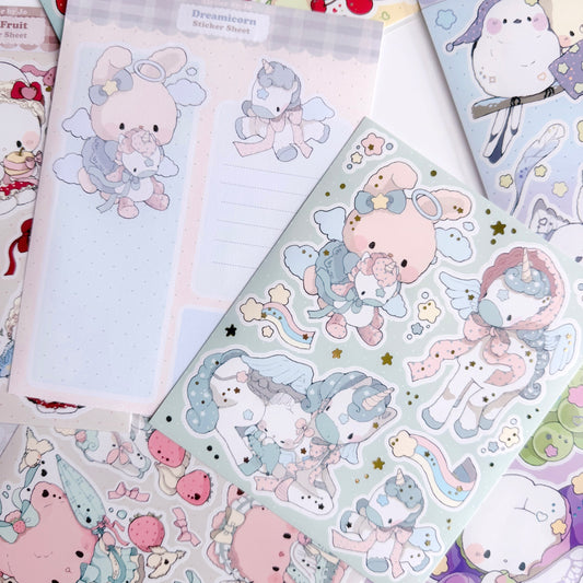 Sticker sheets with cute animal designs on a teal background