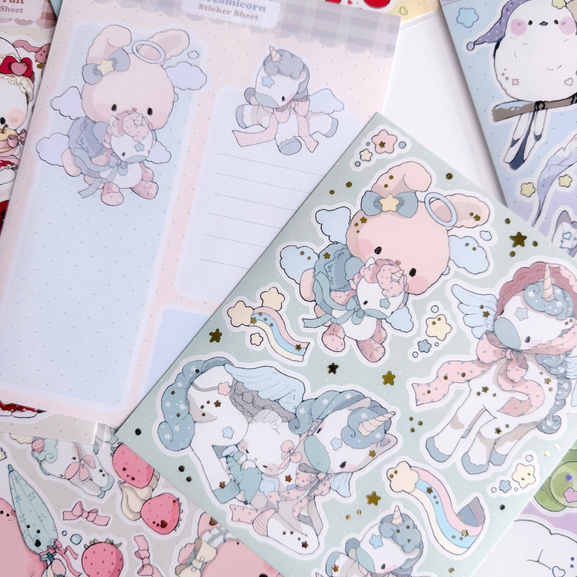 Sticker sheets with cute animal designs on a teal background